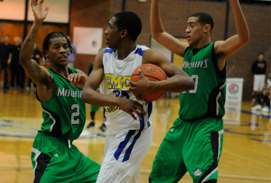 Erick Andrews and Elvis Nunez of Machias defend De'Anthony McCormick of EMCC in the first round of the Elite Eight Tournament Friday night.